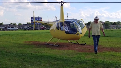 photo of Chris walking by helicopter